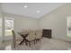 Elegant dining room with a modern table set, complemented by natural light streaming through the windows at 3506 Seaway Dr, New Port Richey, FL 34652