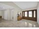 Foyer with marble floors, wooden console table, and decorative front doors at 3506 Seaway Dr, New Port Richey, FL 34652