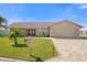Charming single-story home boasts a well-manicured lawn, brick driveway and decorative trees under a bright blue sky at 3506 Seaway Dr, New Port Richey, FL 34652