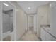 Hallway featuring tile floors, paint, and views of the shower and vanity at 3506 Seaway Dr, New Port Richey, FL 34652