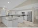 Modern white kitchen with stainless steel appliances, granite countertops, and ample cabinet space at 3506 Seaway Dr, New Port Richey, FL 34652