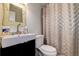 A compact bathroom with a pedestal sink, toilet, and shower with curtain at 3647 Lake St George Dr, Palm Harbor, FL 34684