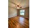 Bedroom featuring hardwood floors, a ceiling fan, and a bright window at 3647 Lake St George Dr, Palm Harbor, FL 34684