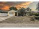 Charming single-story home with attached garage and mature trees in a quiet neighborhood at 3647 Lake St George Dr, Palm Harbor, FL 34684