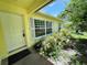 Inviting front entrance with a bright yellow door, large window, and well-manicured landscaping at 3647 Lake St George Dr, Palm Harbor, FL 34684