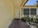 Inviting front porch featuring a white door, neutral paint and meticulous landscaping at 3647 Lake St George Dr, Palm Harbor, FL 34684