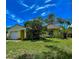 Welcoming single-story home with attached garage, and mature landscaping for added privacy in a lush setting at 3647 Lake St George Dr, Palm Harbor, FL 34684
