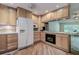 Well-lit kitchen boasts updated appliances, generous countertop space, and sleek wood flooring at 3647 Lake St George Dr, Palm Harbor, FL 34684