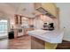 Bright kitchen featuring neutral cabinets, tile countertops, modern appliances, and lots of sunlight at 3647 Lake St George Dr, Palm Harbor, FL 34684