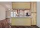 Spacious kitchen with wood cabinets, tile countertops, and modern appliances, perfect for cooking and entertaining at 3647 Lake St George Dr, Palm Harbor, FL 34684