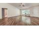 Bright living room with hardwood floors, a ceiling fan, and a large window letting in natural light at 3647 Lake St George Dr, Palm Harbor, FL 34684