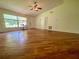 Bright living room with hardwood floors, fan, and lots of natural light at 3647 Lake St George Dr, Palm Harbor, FL 34684
