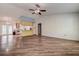Spacious living room featuring hard surface floors, neutral walls, and an open concept to the kitchen at 3647 Lake St George Dr, Palm Harbor, FL 34684