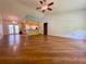 Bright and airy living room with hardwood floors, and an open layout connecting to the kitchen and dining area at 3647 Lake St George Dr, Palm Harbor, FL 34684