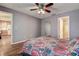 Spacious bedroom featuring wood-style flooring, ensuite bath, and access to kitchen at 3647 Lake St George Dr, Palm Harbor, FL 34684