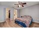 Cozy bedroom boasts wood flooring, a ceiling fan, closet, and an en-suite bathroom at 3647 Lake St George Dr, Palm Harbor, FL 34684