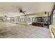 This large screened-in patio includes tile flooring, ceiling fans, and a jacuzzi at 3647 Lake St George Dr, Palm Harbor, FL 34684