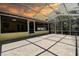 Screened patio with concrete flooring and enclosed roof at 3647 Lake St George Dr, Palm Harbor, FL 34684