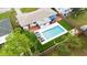 An aerial shot showcasing a beautiful home with a backyard pool and outdoor living area, surrounded by lush landscaping at 416 Graham Dr, Clearwater, FL 33765
