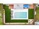 An aerial view of a stunning backyard featuring a pool, lounge area, and a beautifully manicured lawn at 416 Graham Dr, Clearwater, FL 33765
