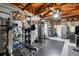 Finished basement with home gym, exposed rafters, and storage space at 416 Graham Dr, Clearwater, FL 33765