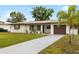 Inviting single-story home features a long driveway and fresh landscaping at 416 Graham Dr, Clearwater, FL 33765