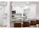 Renovated kitchen with modern appliances, granite countertops, and sleek breakfast bar at 416 Graham Dr, Clearwater, FL 33765