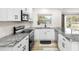 Updated kitchen featuring granite countertops, stainless steel appliances, and sleek white cabinetry at 416 Graham Dr, Clearwater, FL 33765