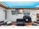Inviting covered outdoor living space featuring a TV and comfortable seating, perfect for relaxation and entertaining at 416 Graham Dr, Clearwater, FL 33765