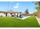 Backyard pool with green grass and outdoor seating at 416 Graham Dr, Clearwater, FL 33765