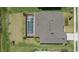 Birds-eye view of an estate featuring a screened pool and jacuzzi at 4423 Pond Brook Ct, Bradenton, FL 34211
