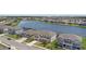 Aerial perspective showcasing a community of homes surrounding a serene lake, highlighting neighborhood layout at 4423 Pond Brook Ct, Bradenton, FL 34211