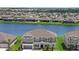Aerial view of a luxury home overlooking beautiful water views, with neighboring homes nearby at 4423 Pond Brook Ct, Bradenton, FL 34211
