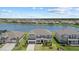 Aerial shot of a lakeside home featuring a well-maintained lawn and proximity to community amenities and lush greenery at 4423 Pond Brook Ct, Bradenton, FL 34211