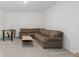 Cozy finished basement with a large sectional sofa and a foosball table at 4423 Pond Brook Ct, Bradenton, FL 34211