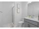 Modern bathroom with a glass-enclosed shower, gray vanity, and stylish fixtures at 4423 Pond Brook Ct, Bradenton, FL 34211