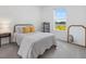 Cozy bedroom with a full size bed, bright window with a lake view, and minimalist decor at 4423 Pond Brook Ct, Bradenton, FL 34211