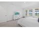 Bright bedroom with a view of the lake, and featuring a white dresser and neutral decor at 4423 Pond Brook Ct, Bradenton, FL 34211