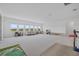 Large bonus room with expansive windows overlooking a lake and furniture at 4423 Pond Brook Ct, Bradenton, FL 34211