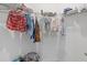 Walk-in closet with metal racking that is fully stocked with clothes and storage at 4423 Pond Brook Ct, Bradenton, FL 34211