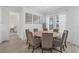 Bright dining area boasts a round table, seating for eight, and serene water views at 4423 Pond Brook Ct, Bradenton, FL 34211