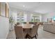 Bright dining area boasts a round table, seating for eight, and sliding doors to the pool at 4423 Pond Brook Ct, Bradenton, FL 34211