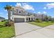 Gray two-story home featuring a two car garage, complemented by an inviting front porch and manicured lawn at 4423 Pond Brook Ct, Bradenton, FL 34211