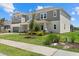 Two-story gray home with a well-manicured lawn and mature landscaping, offering curb appeal at 4423 Pond Brook Ct, Bradenton, FL 34211