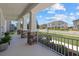 Charming front porch with decorative stone pillars offers a welcoming entrance to the home and neighborhood views at 4423 Pond Brook Ct, Bradenton, FL 34211