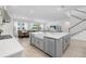 Open concept kitchen with an island, bar seating, and views into dining and living areas at 4423 Pond Brook Ct, Bradenton, FL 34211