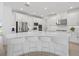 A bright, modern kitchen features white cabinets, stainless steel appliances, and a large center island at 4423 Pond Brook Ct, Bradenton, FL 34211