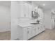 Modern kitchen features white cabinets, subway tile backsplash, and stainless steel vent hood at 4423 Pond Brook Ct, Bradenton, FL 34211
