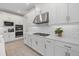 Modern kitchen with stainless steel appliances, white cabinets, and subway tile backsplash at 4423 Pond Brook Ct, Bradenton, FL 34211