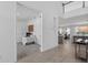 A pristine office space features a large workspace and an open entryway leading to a cozy living area at 4423 Pond Brook Ct, Bradenton, FL 34211